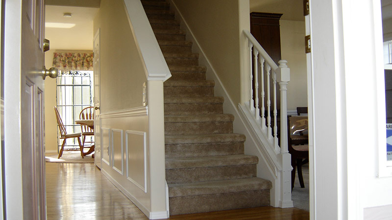 Carpeted staircase leading to dining area