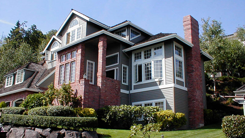 Large two-story suburban house with brick chimney