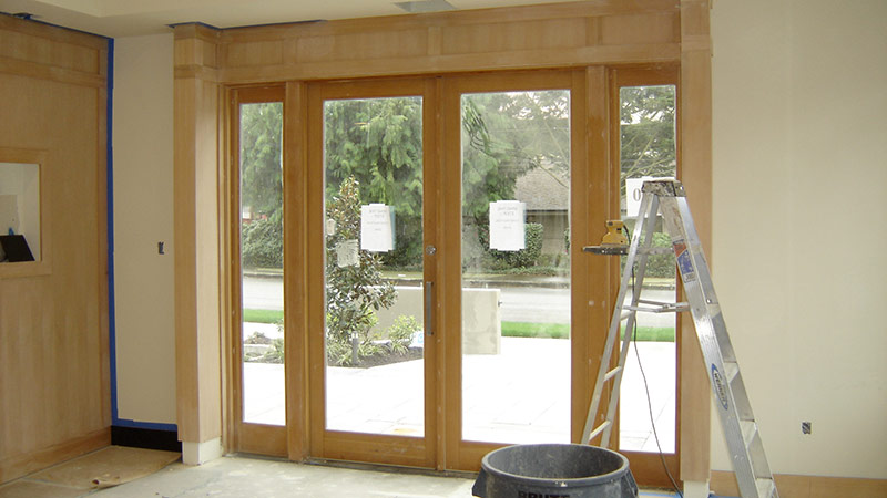 Wooden framed glass entry doors during renovation