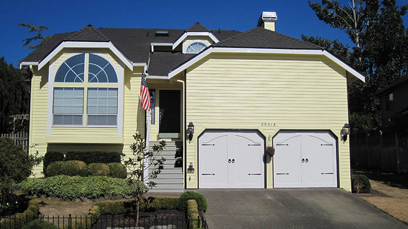 Yellow suburban house with double garage