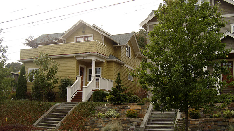 Yellow house with terraced stone front steps