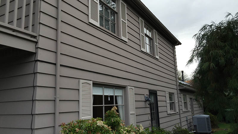 Gray two-story house siding with shuttered window