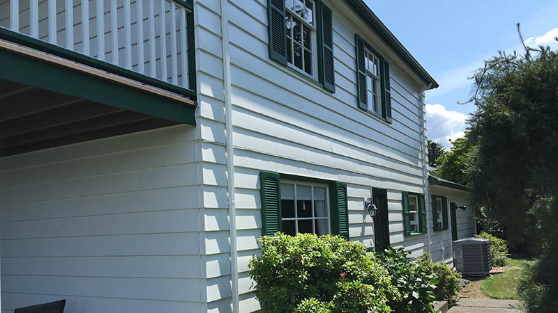 White two-story house with green shutters