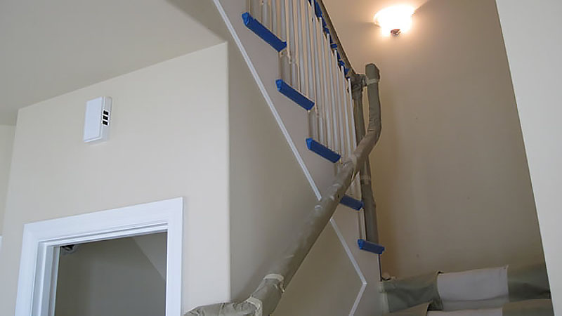 Staircase railing wrapped in protective padding