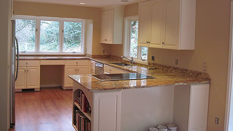 Bright modern kitchen with granite island and cabinets