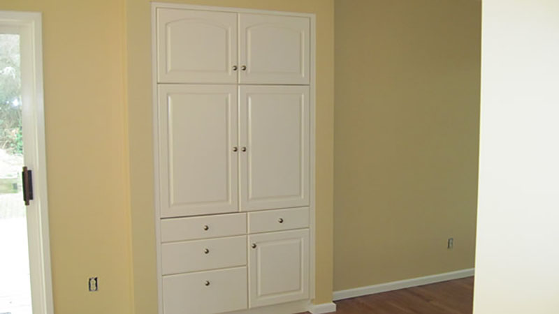 White built-in cabinets and drawers in vacant room