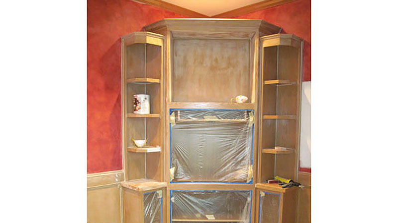 Unfinished built-in shelving with plastic-covered openings