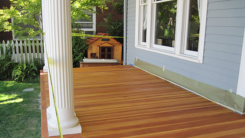 Wooden porch deck with white column