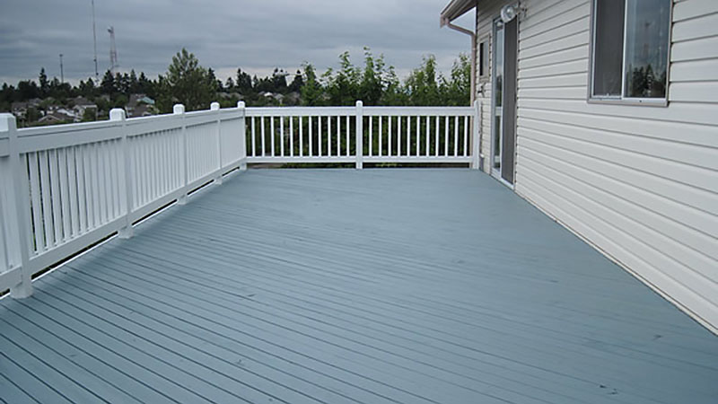 Spacious blue deck with white railing