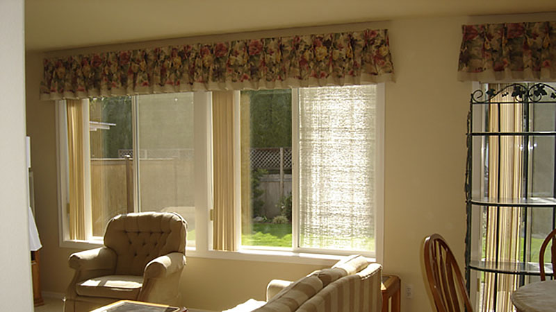 Sunlit living room with armchairs and windows