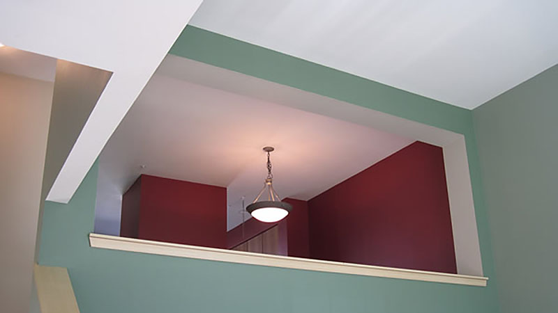 Green and red interior loft with chandelier
