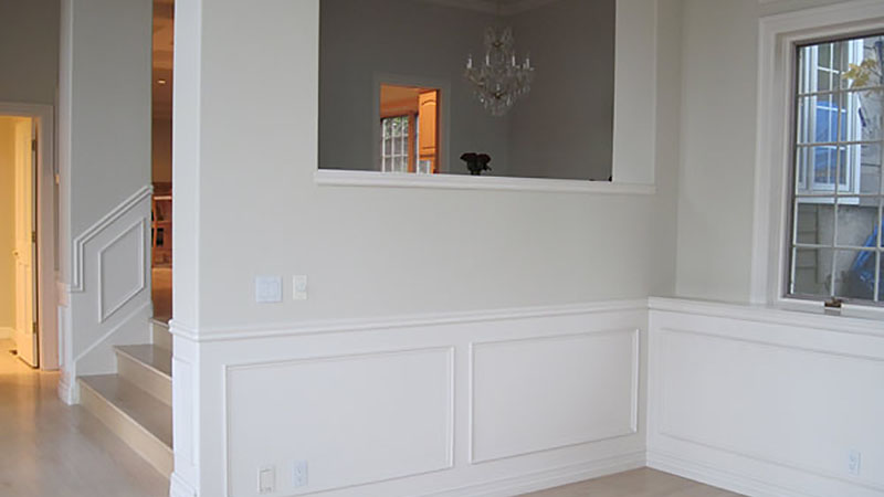 Empty room with white wainscoting and window