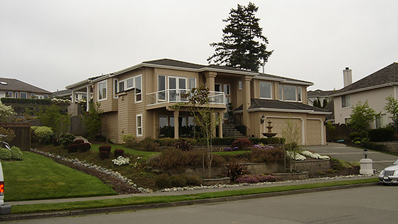 Large two-story suburban house with landscaped yard