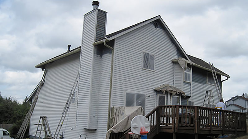 Gray two-story house under exterior renovation