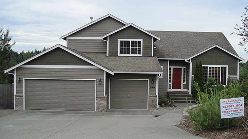 Gray two-story suburban house with three-car garage