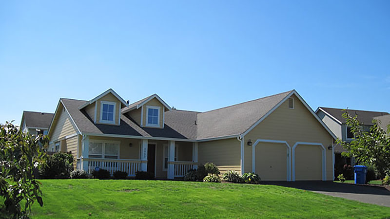 Suburban house with garage and green lawn