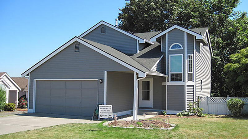 Gray two-story suburban house with attached garage