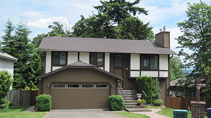 Brown two-story suburban house with garage