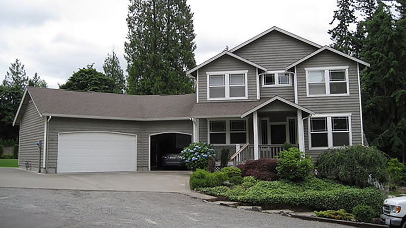 Two-story gray house with attached garage