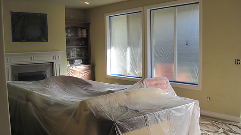Living room furniture covered in protective plastic