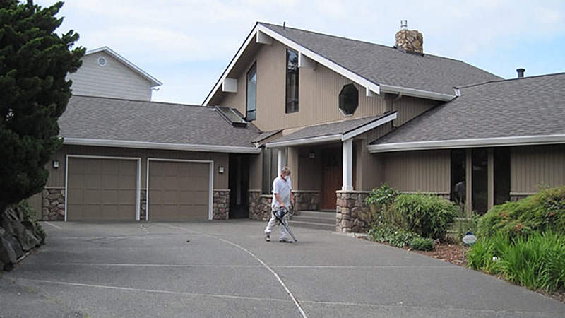Suburban house driveway with person walking