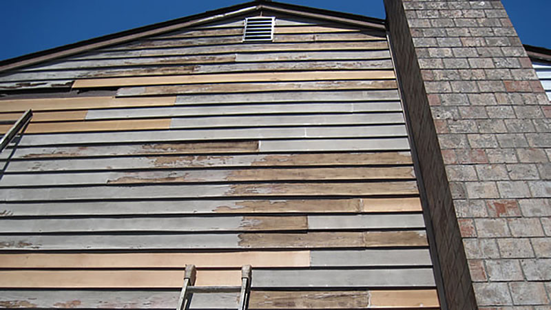 Weathered wooden siding on house with chimney