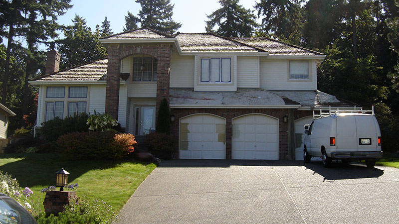 Two-story suburban house with white work van