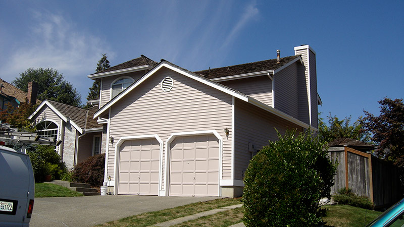 Beige two-story suburban house with two-car garage
