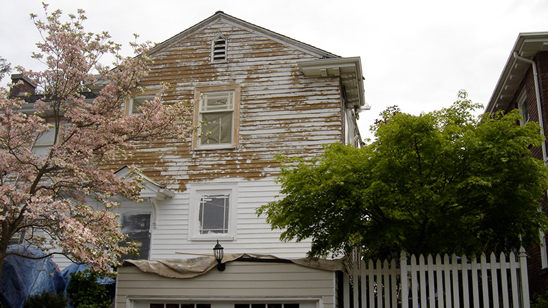 Weathered two-story house with peeling paint