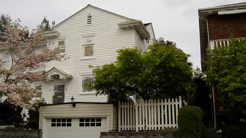 White two story house with picket fence