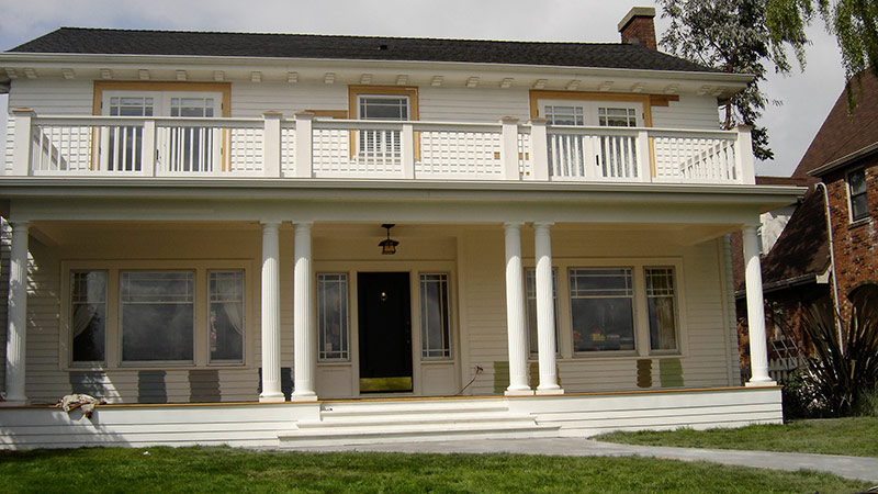 Two-story white house with porch and columns