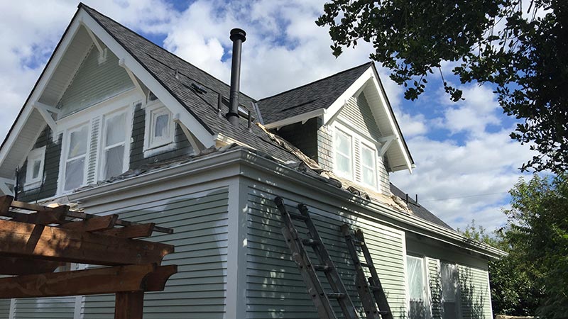 Two-story house with roof repair ladders