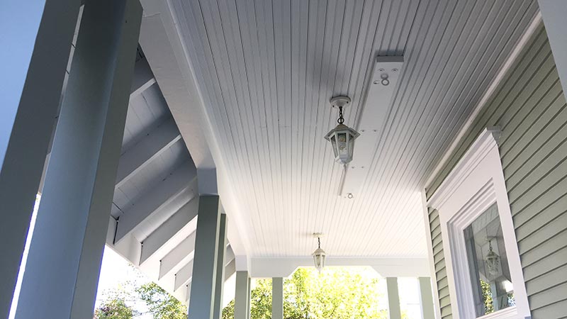 Covered porch ceiling with hanging lanterns