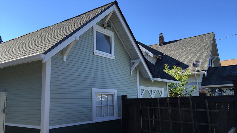 Light green house exterior with pitched roof