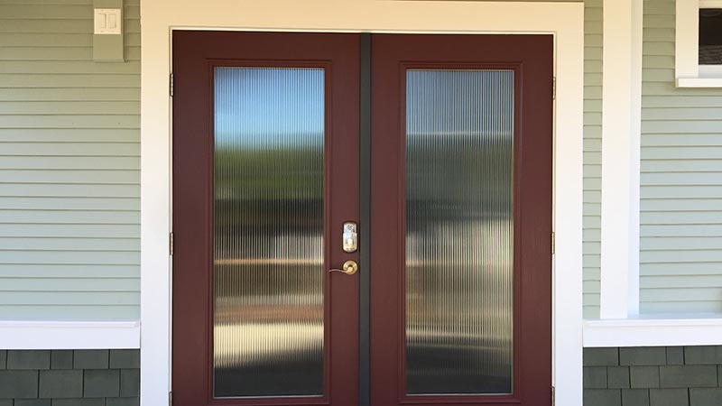 Burgundy double doors with ribbed glass panels