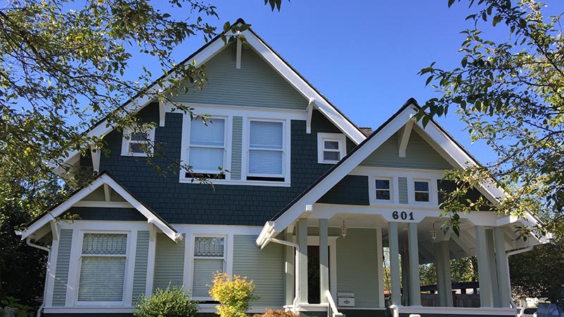 Green craftsman-style house with front porch