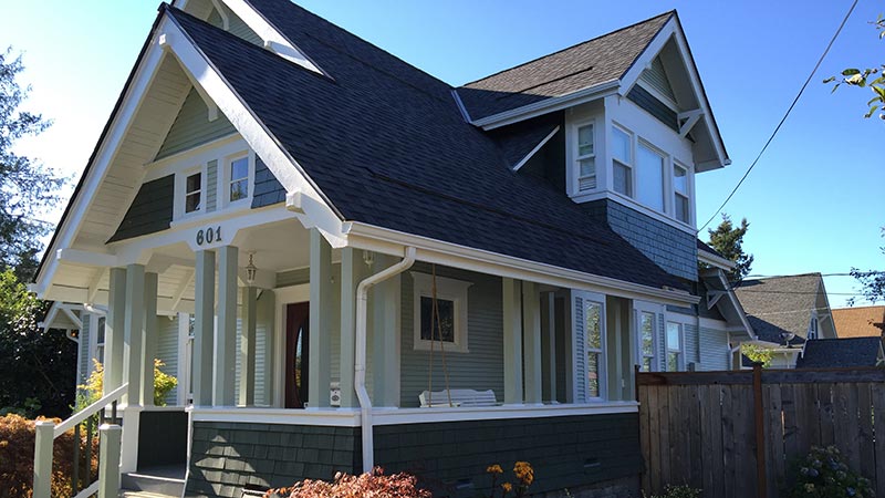 Green Craftsman-style house with front porch