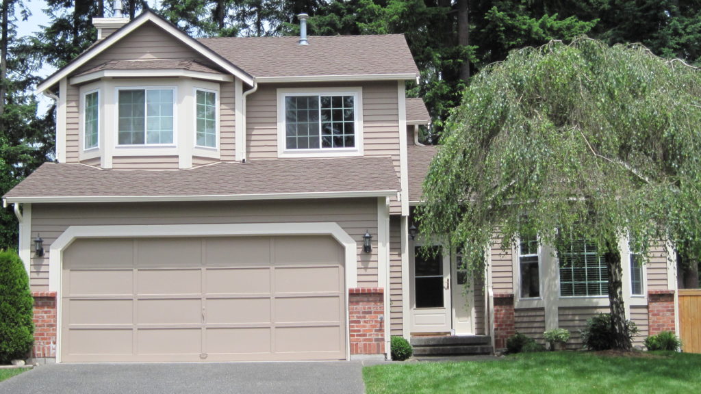 Beige two-story suburban house with garage