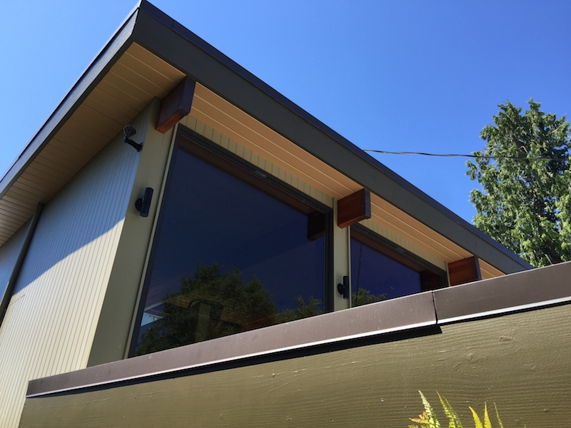 Modern house exterior with large slanted window